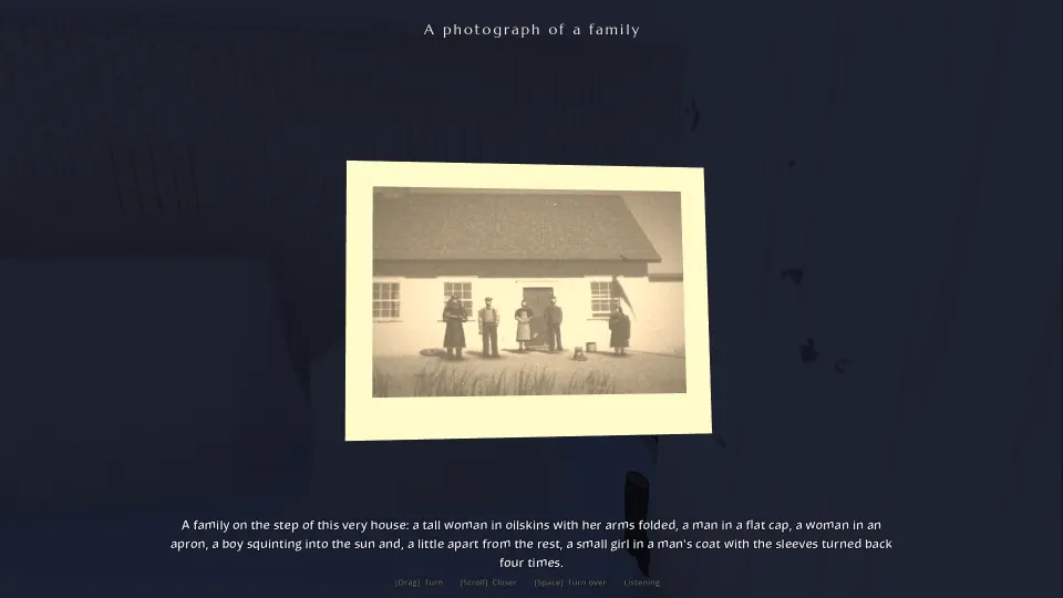 Holding up an old sepia photograph of a family outside the keeper's house, with a subtitle describing the people in it.